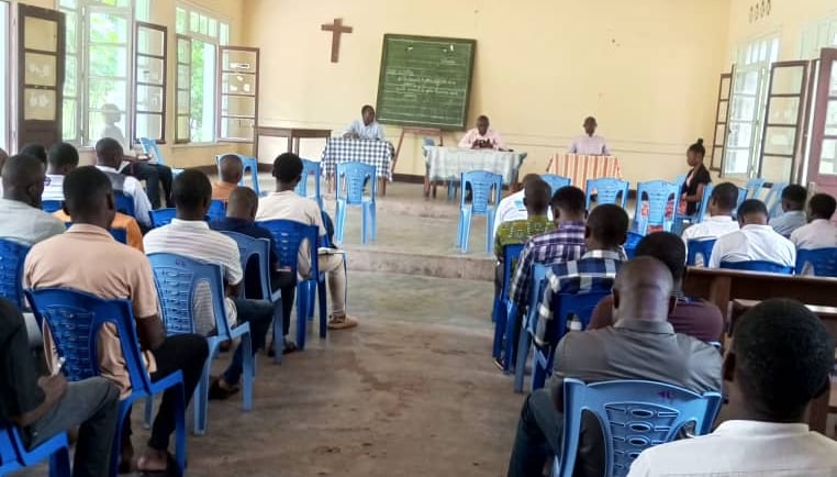 a group of students of UCGB sitting in chairs in a room