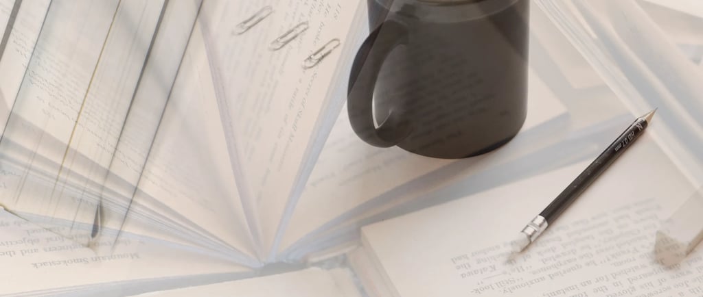 a cup of coffee and a pen on a table