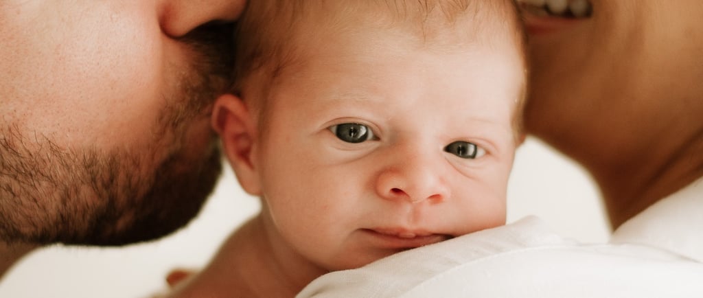 newborn in parents arms, in studio shoot Littlehampton