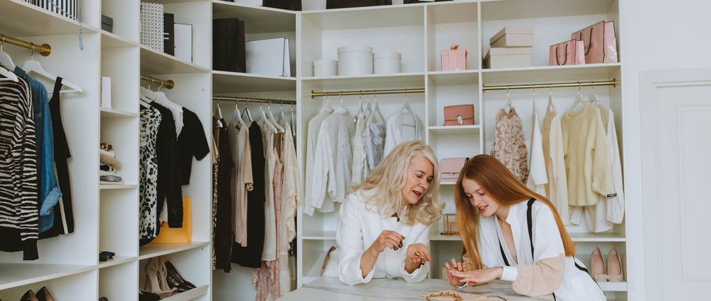 two women in white robes standing in a closet