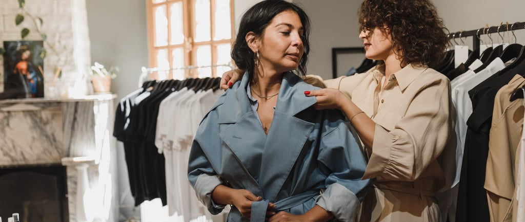 a woman in a blue robe is standing in front of a fireplace