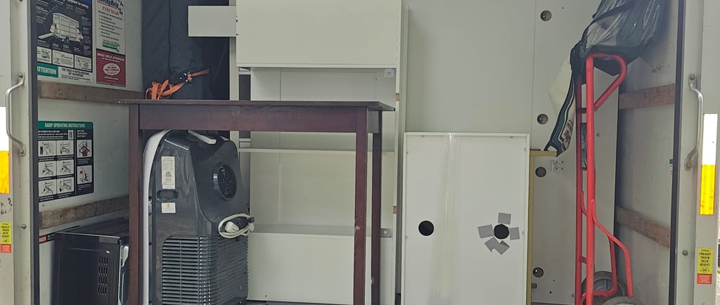 a truck with a refrigerator and cabinets in the back of it