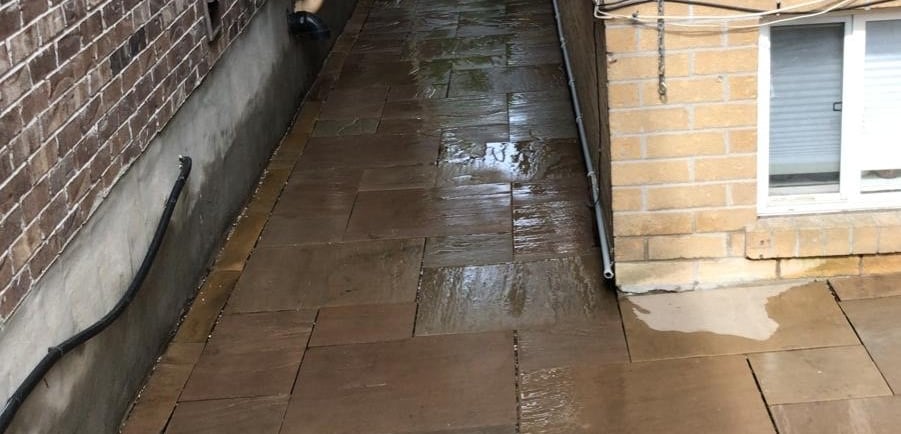 Flagstone walkway leading into backyard