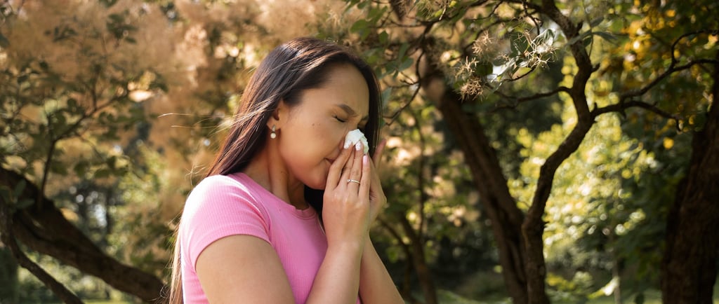 Side view of woman blowing her nose