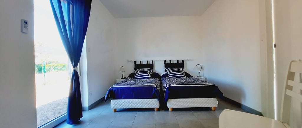 a bedroom with two beds and a table