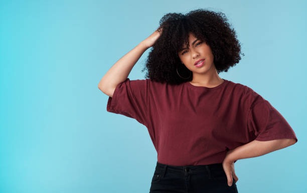 a woman with a curly afro hairs and a red shirt