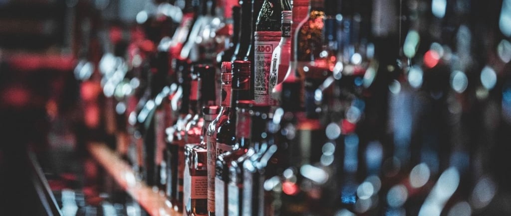 a bunch of bottles of alcohol on a bar