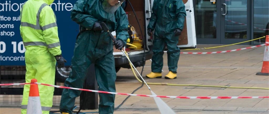 A small group of men cleaning a city walkway