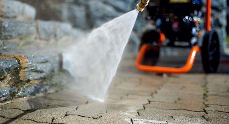 Pressure washer cleaning a paved path