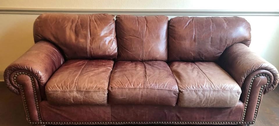 vintage brown leather sofa with pined trim