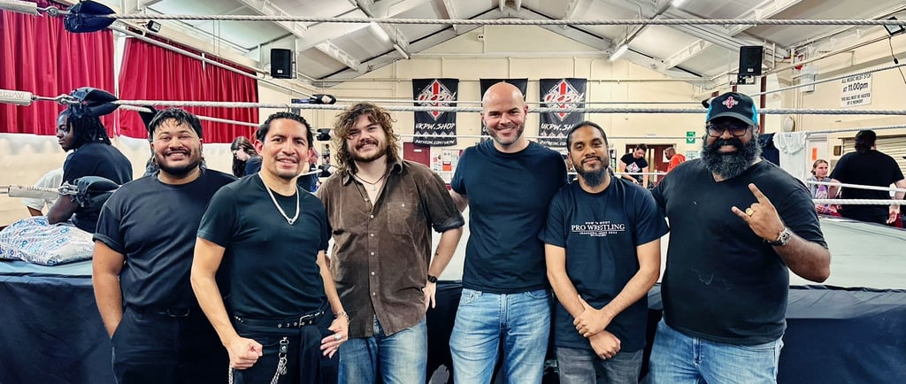 a group of students stand infront of a wrestling ring