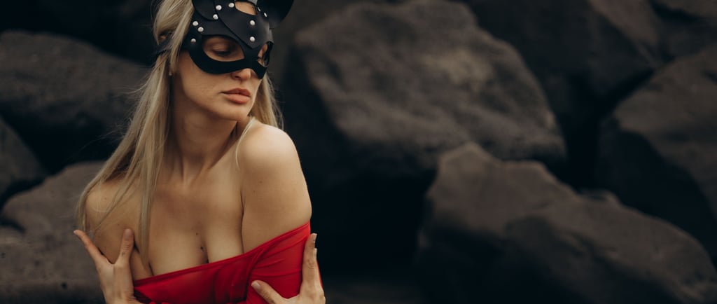a woman in a red dress and black cat mask