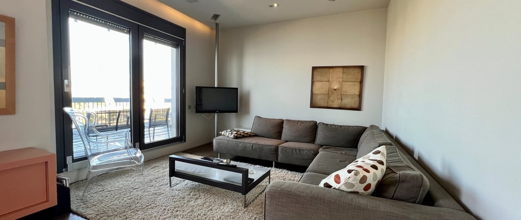 a living room with a couch and a television in thessaloniki