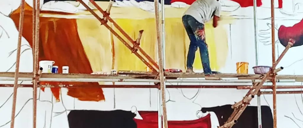 a man is painting a mural of a painting of a man 