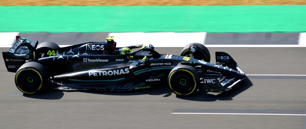 a racing car with a driver and background blur