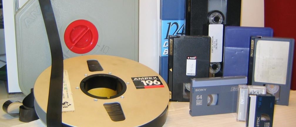 Collection of vintage video formats including VHS, Betacam, and DVCAM cassettes.