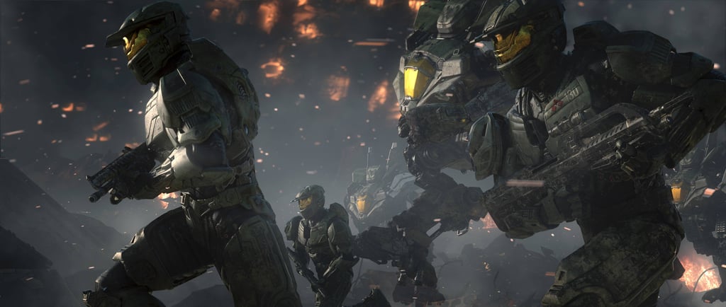 Spartan soldiers in green MJOLNIR armor battle across a fiery warzone in a scene from Halo Wars 2.