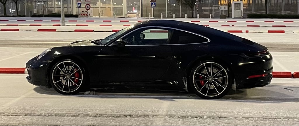 a black porsche 911 porsche 992.1 porsche