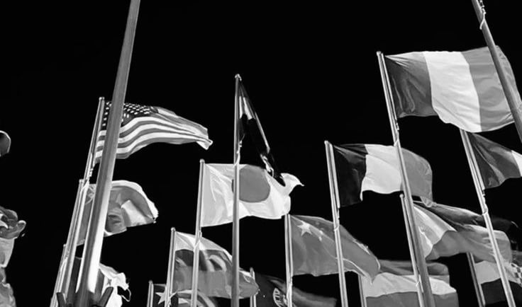 a bunch of flags are flying in the air