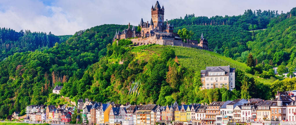 Cochem Imperial Castle overlooks the Moselle River and colorful medieval houses in Germany.