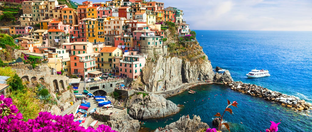 Colorful cliffside houses of Manarola in Cinque Terre Italy overlooking the Mediterranean Sea.