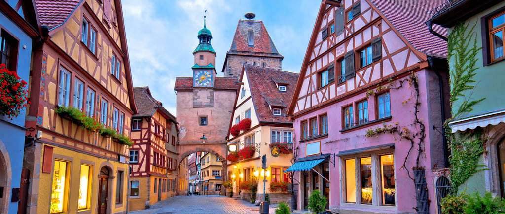Colorful half-timbered houses along a cobblestone street in Rothenburg ob der Tauber, Germany.