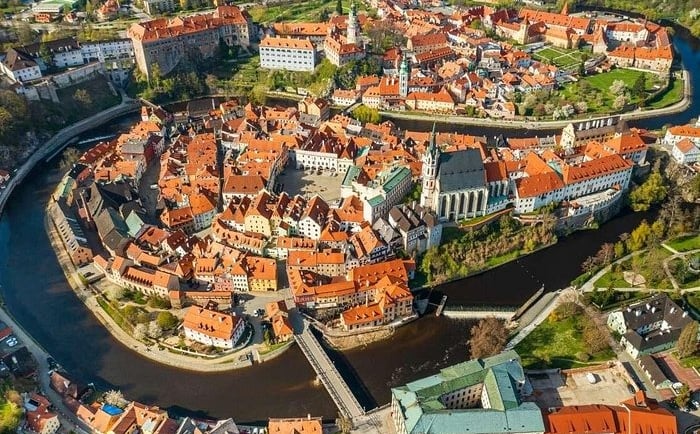 Aerial view of Cesky Krumlov historic town center and Vltava River in Czech Republic.