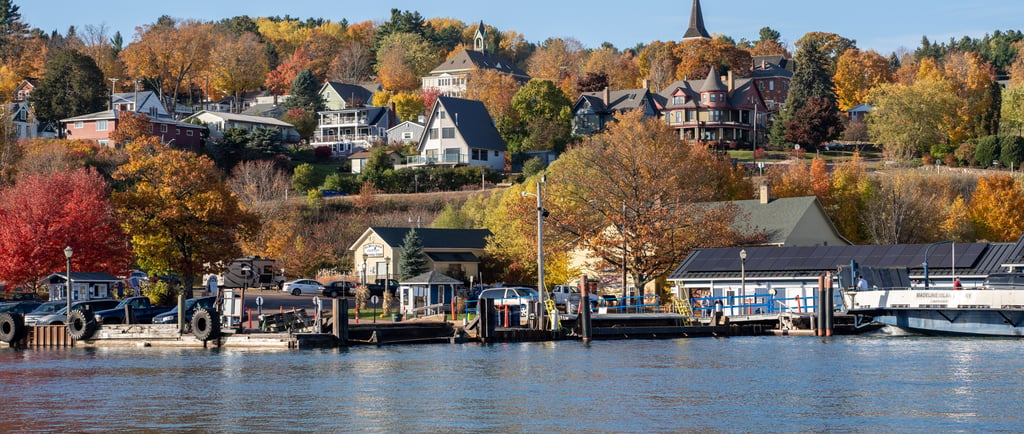 Scenic view of Bayfield, Wisconsin shoreline with autumn fall foliage and Madeline Island Ferry dock.