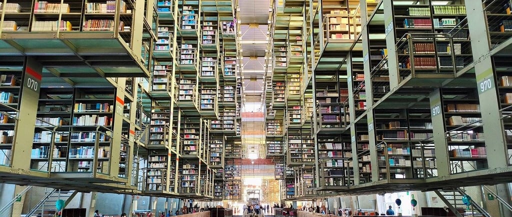Modern Vasconcelos Library interior in Mexico City featuring suspended steel bookshelves and architectural symmetry.