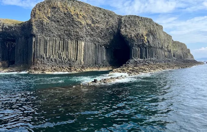 Fingal's Cave on the Isle of Staffa featuring dramatic basalt columns and sea cliffs in Scotland.