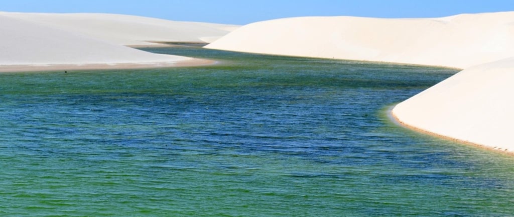 Turquoise freshwater lagoons between white sand dunes in Lencois Maranhenses National Park, Brazil.