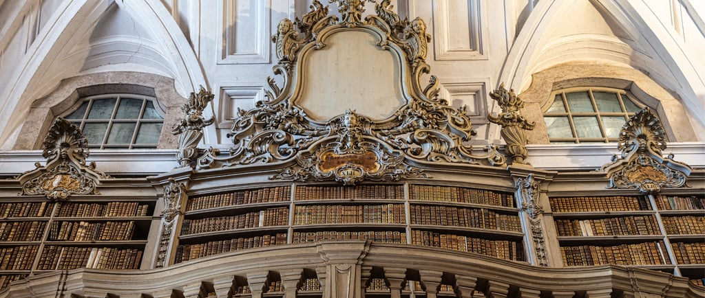 Ornate baroque architecture in a historic library with gold-trimmed bookshelves and intricate carvings.