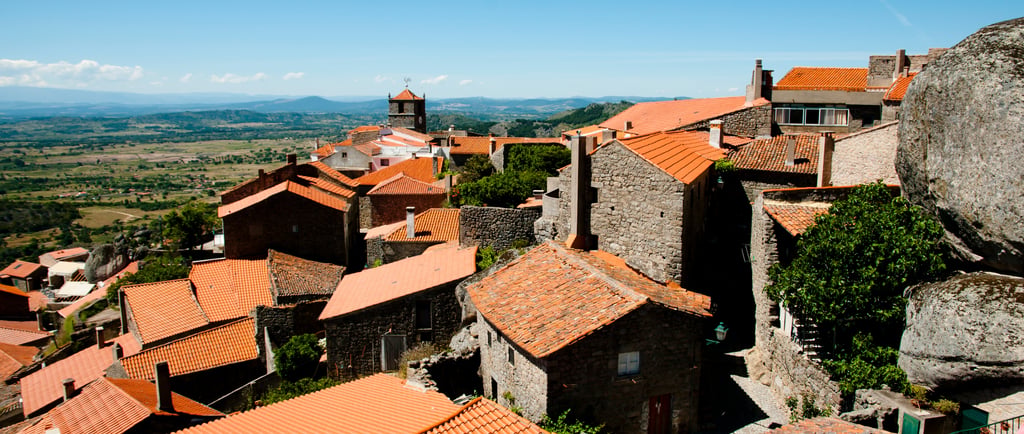 Panoramic view of Monsanto Portugal featuring historic stone houses with orange tiled roofs.
