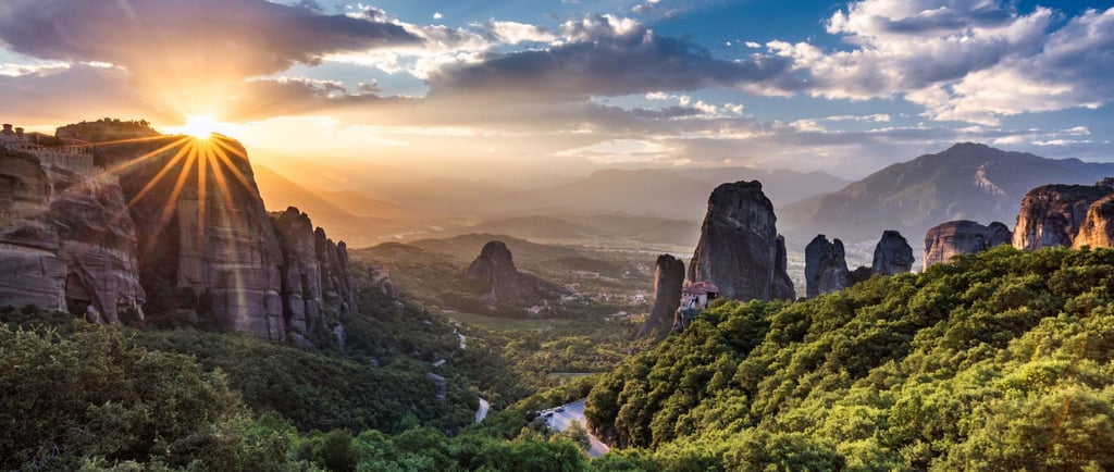 Golden sunset over the ancient Meteora monasteries and rock formations in Greece.