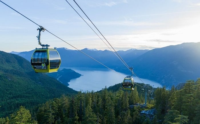Yellow Sea to Sky Gondola cabins overlooking Howe Sound and coastal mountains in Squamish.