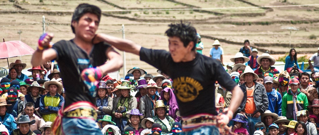 Peruvian men participate in a traditional Takanakuy fighting festival in the Andes mountains.