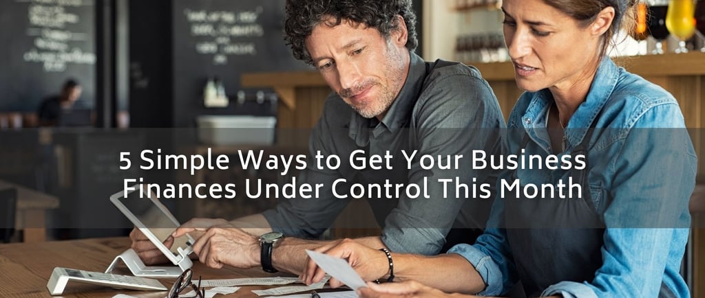 a man and woman sitting at a table with papers and papers