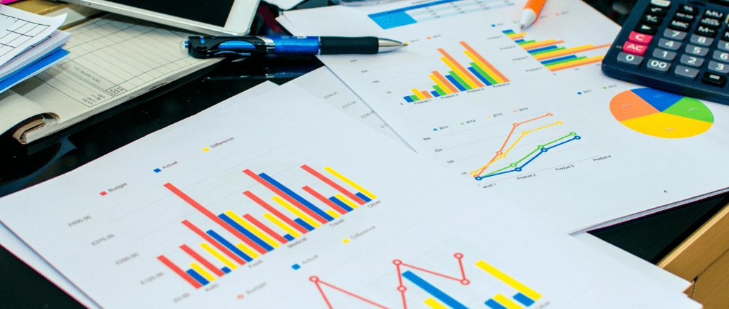 graph reports on desk with calculator