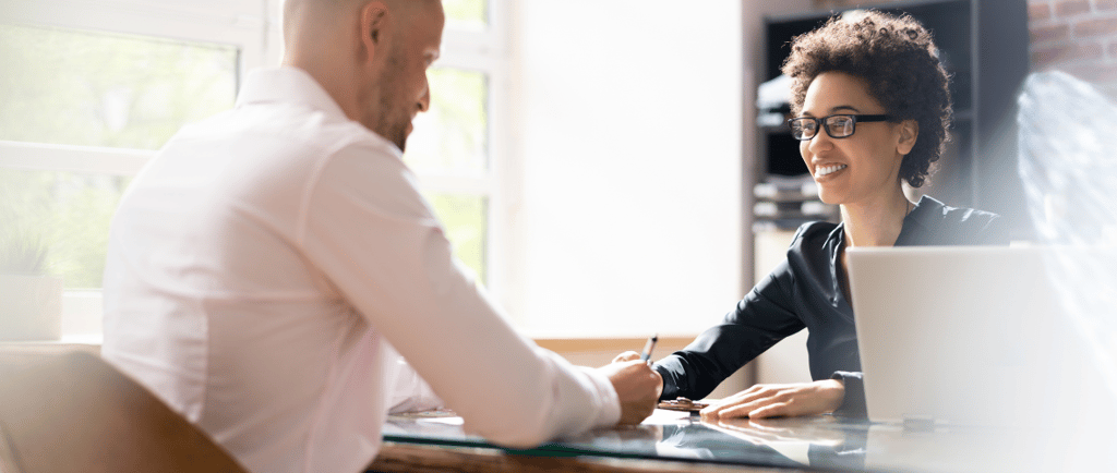 a man and woman sitting at a desk