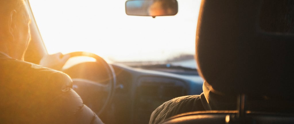 couple driving into sunrise