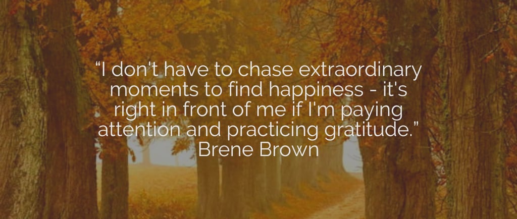 a road leading through trees with a quote from Brene Brown