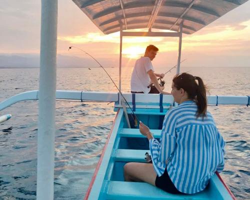 a man and woman waiting sunset for diving jurney on a boat