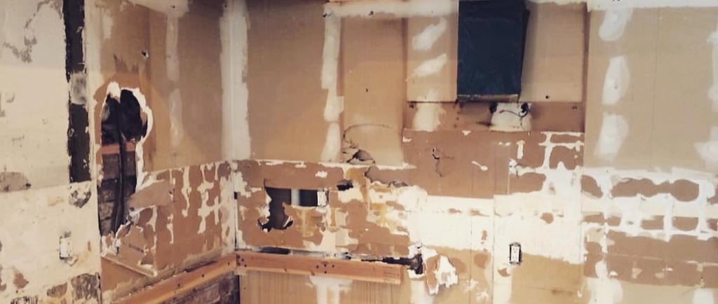 a kitchen with cabinets torn out