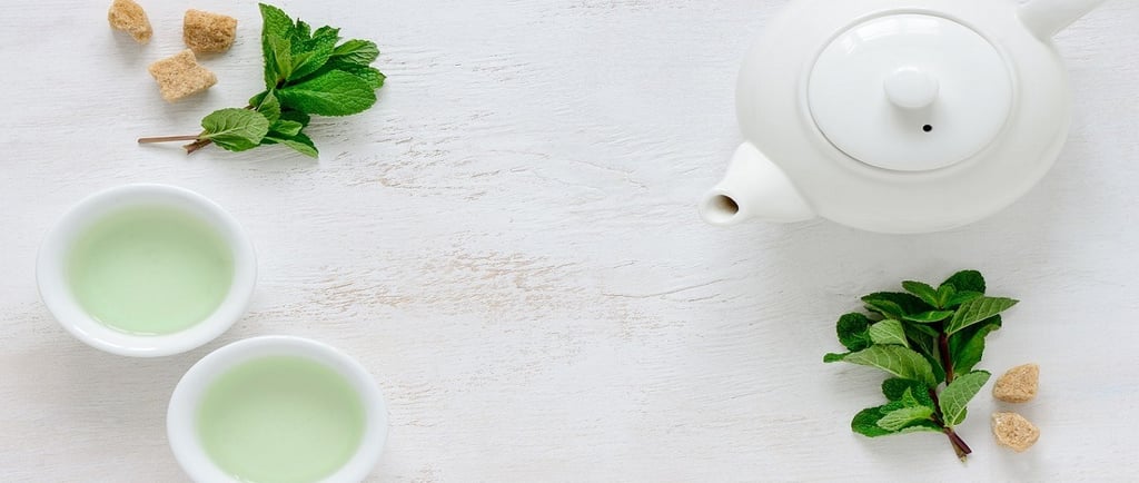 Green Tea in cups and Ceramic Kettle