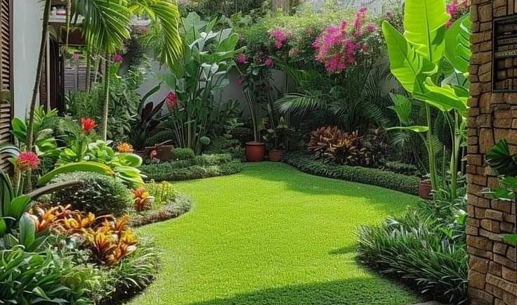 a garden with a lawn and a potted plant