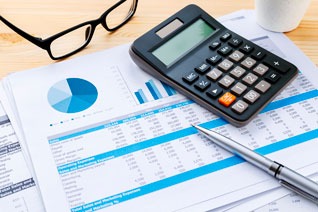 a calculator and a cup of coffee on a desk