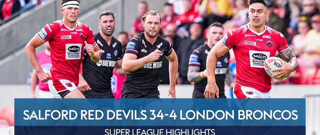 Salford Red Devils and London Broncos - a group of men playing rugby in a stadium