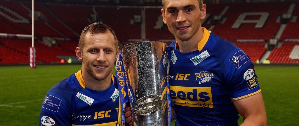two sports men standing next to each other holding a trophy. Burrow and Sinfield after Leeds Rhinos'