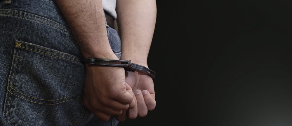 man in handcuffs wearing jeans