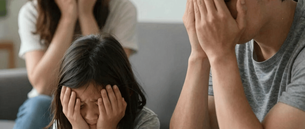 girl covering her face with both hands